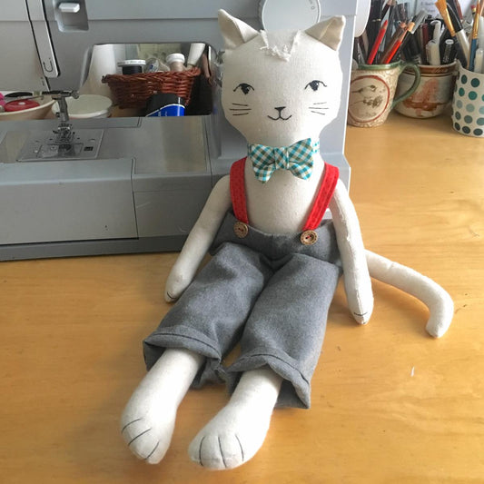 snazzy cat doll wearing trousers bow tie