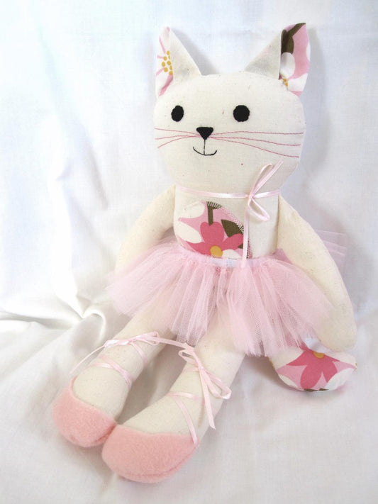 cat doll wearing a pink tutu and ballet shoes