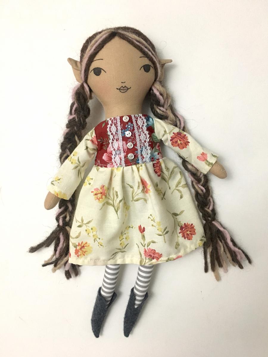 pixie doll wearing a flower dress